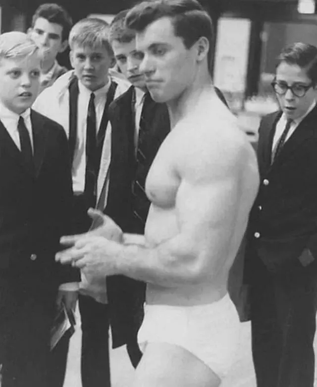 Name: Steve Kotis, physique model - circa 1964. School boys in disbelief of his figure. Unsure why he’s there, anyway next slides are his nudes. He is a man of perfection.