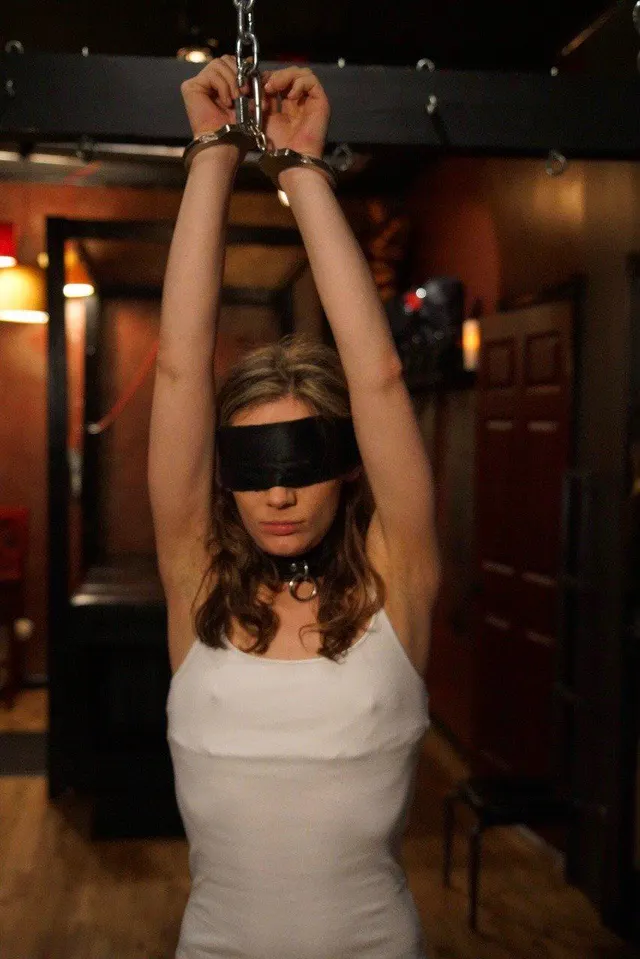 Nicely Handcuffed Above her head with a blindfold on!
