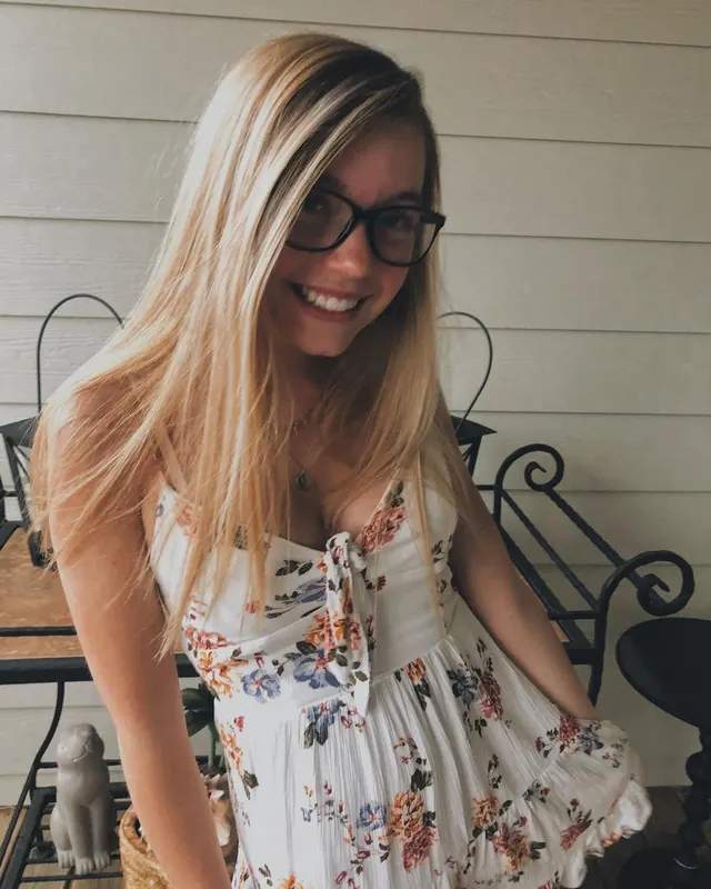 Thick glasses and a smile