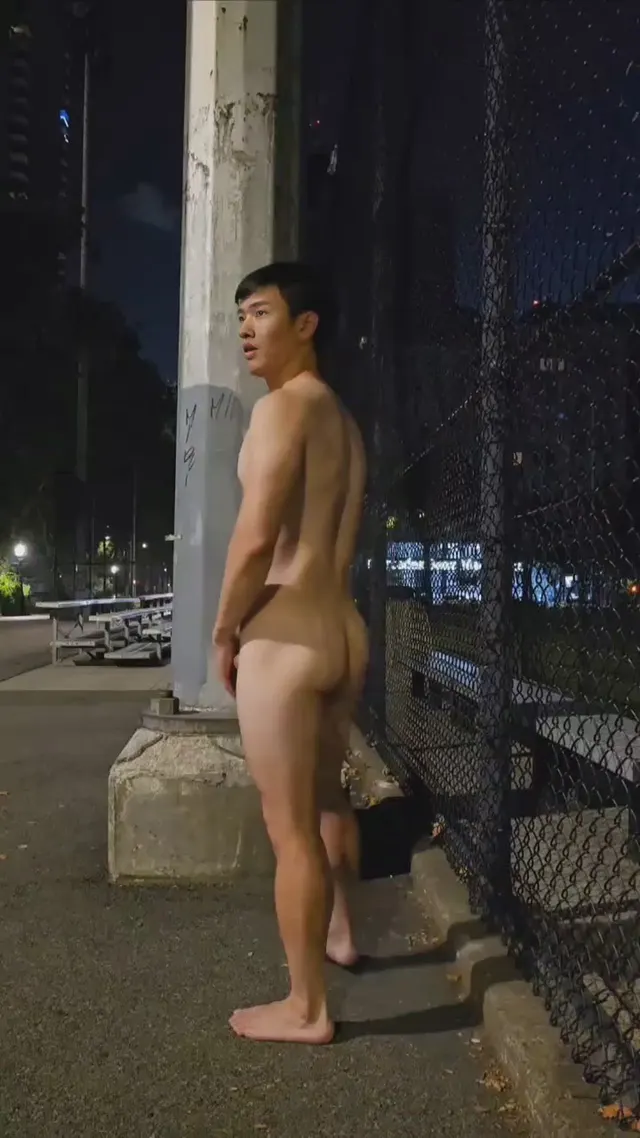 Cumming under a light in a park.