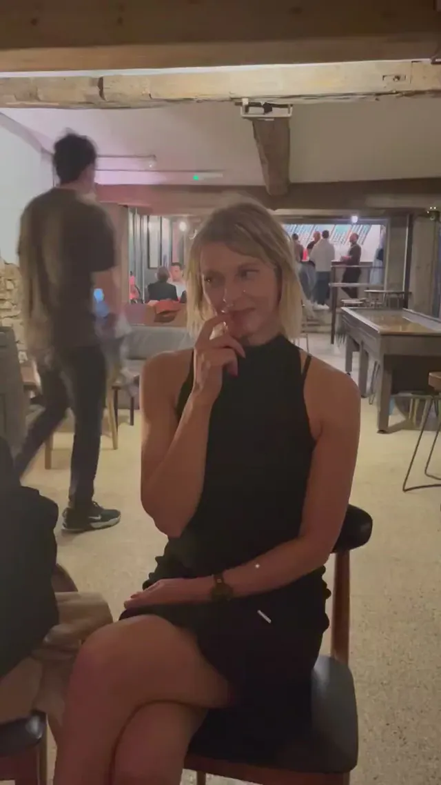 Sitting in a crowded bar wearing a facial