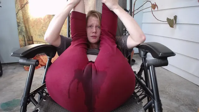 Wetting red yoga pants in a wilderness gynecology chair. ID her?